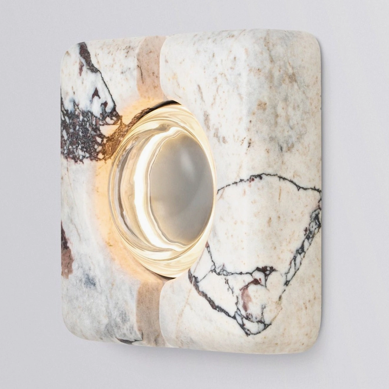 Extreme close-up of recessed wall lamp lens showing LED warm light and clear glass