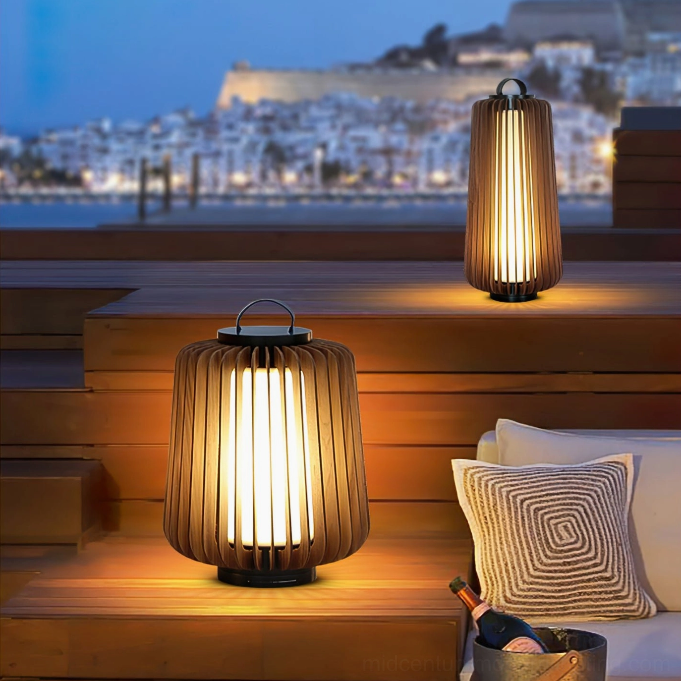 Legno outdoor lantern table lamps on coastal wooden terrace with evening waterfront backdrop