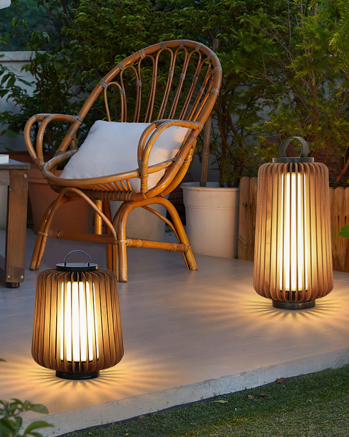 Legno wooden outdoor table lamp on rattan chair with backyard garden and warm decorative lighting