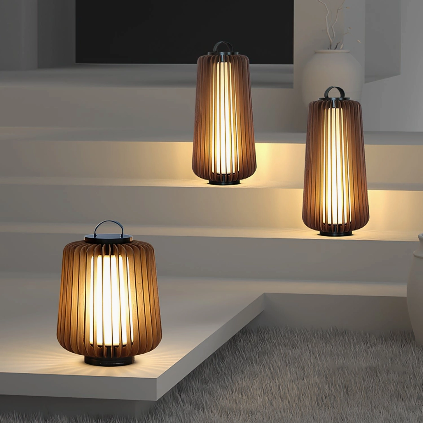Mixed size Legno outdoor lanterns arranged on modern white staircase with neutral minimalist aesthetic