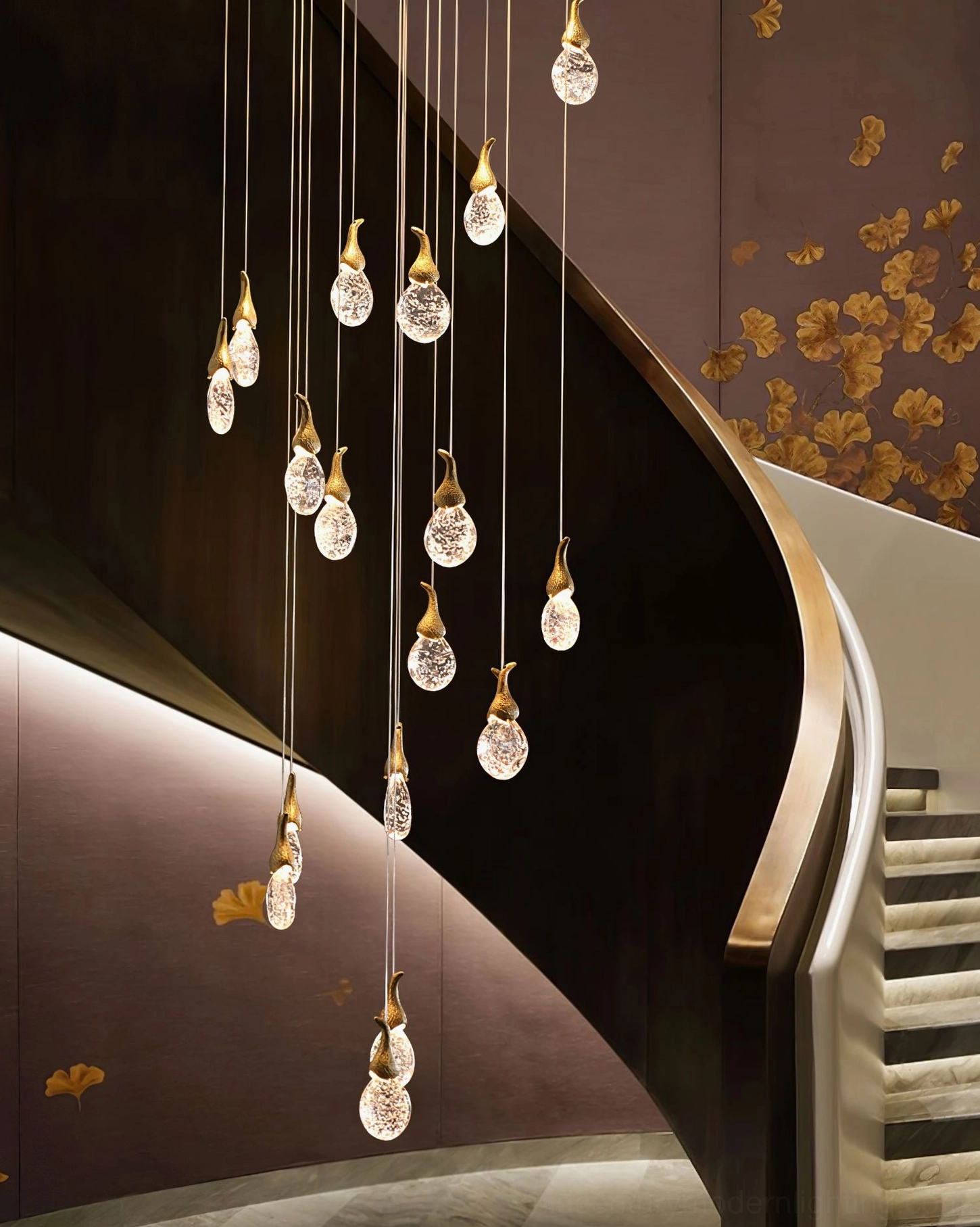 Leo Bubble Chandelier in curved stairwell with clear seeded glass shades and gold metal hardware