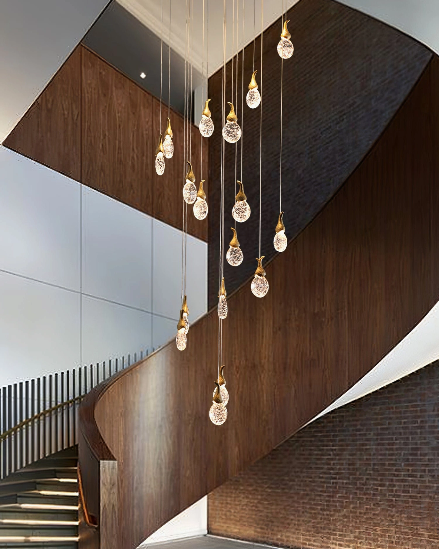 Leo Bubble Chandelier installed in modern spiral stairwell with illuminated clear glass pendants