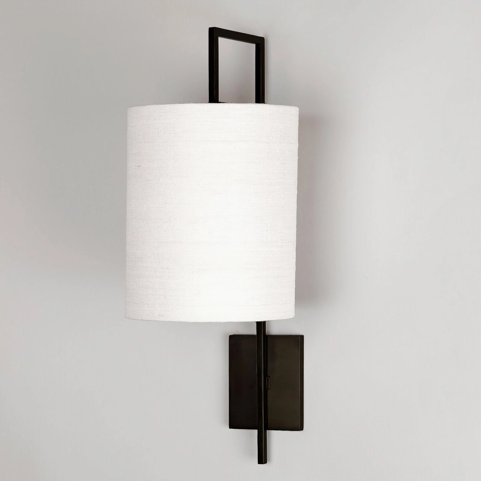 Lewes matte black wall sconce with white fabric shade studio photography