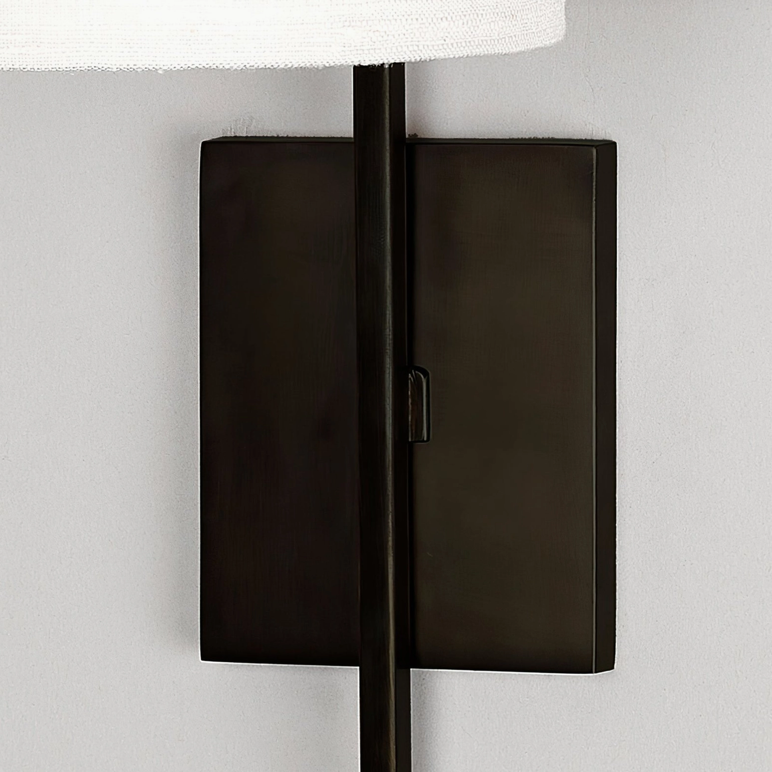 Lewes matte black wall sconce side view showing vertical rod and mounting plate