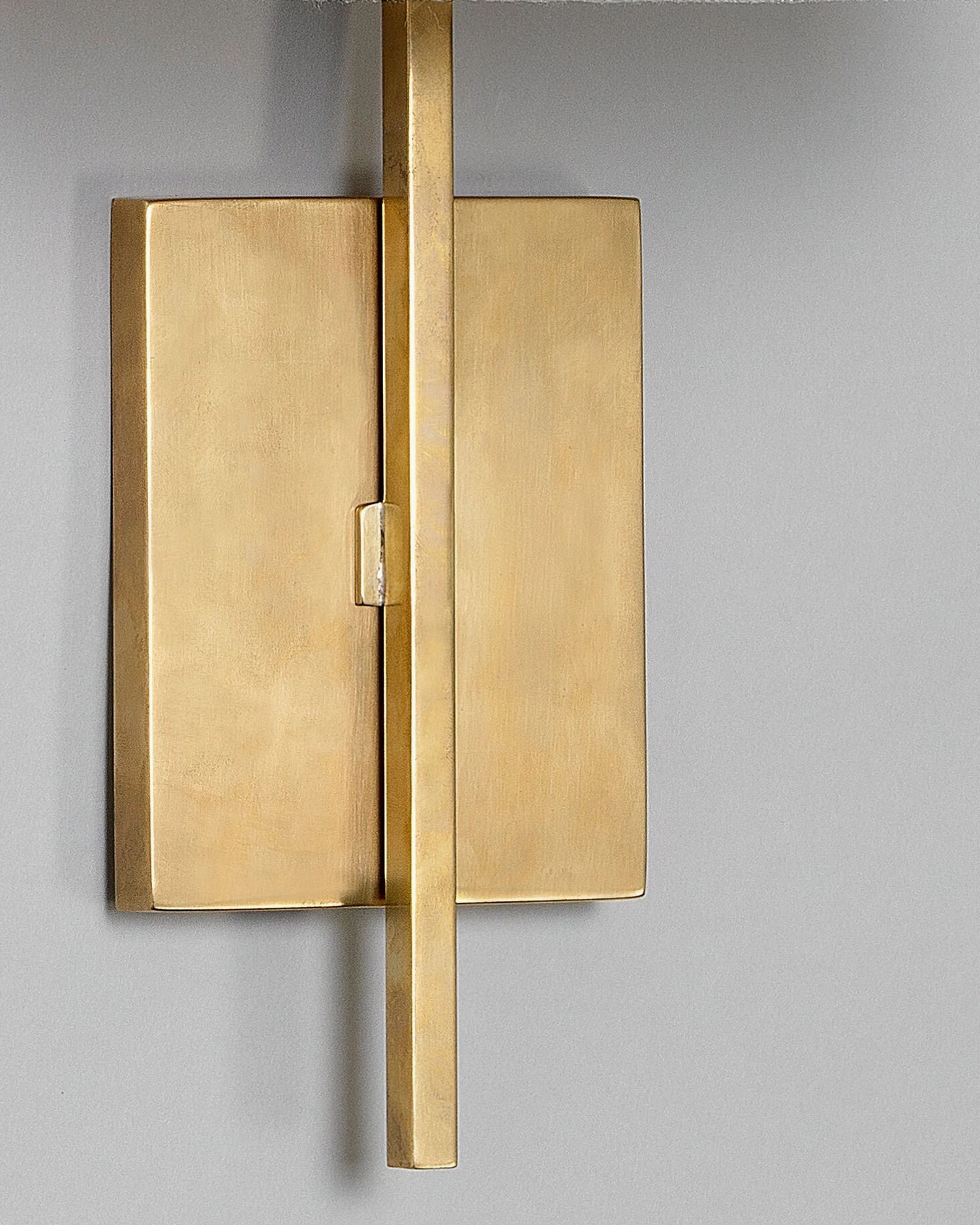 Lewes aged brass wall sconce with vertical metal rod structural detail