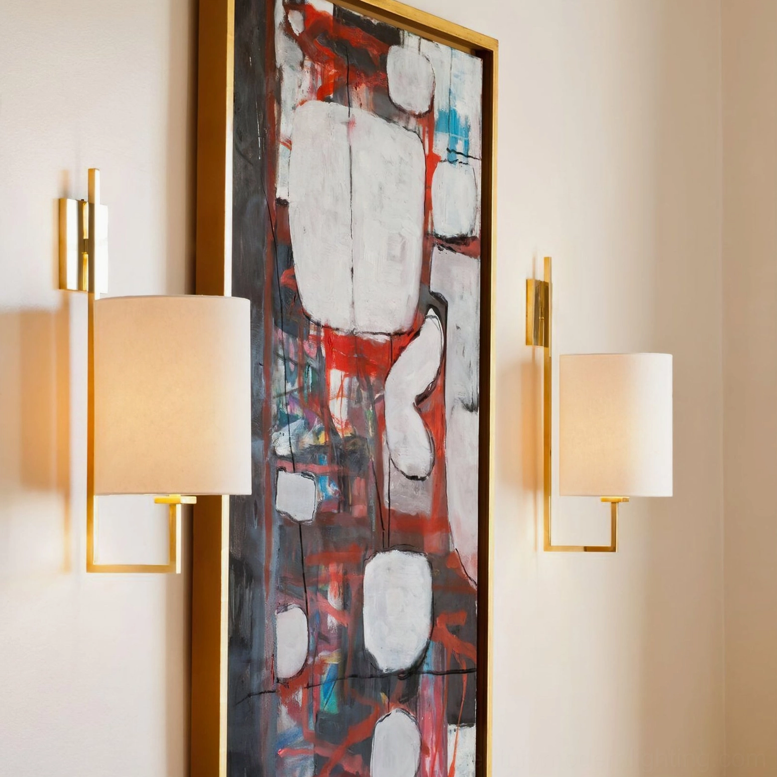 Pair of Lewes brass wall sconces installed in modern bedroom with abstract art