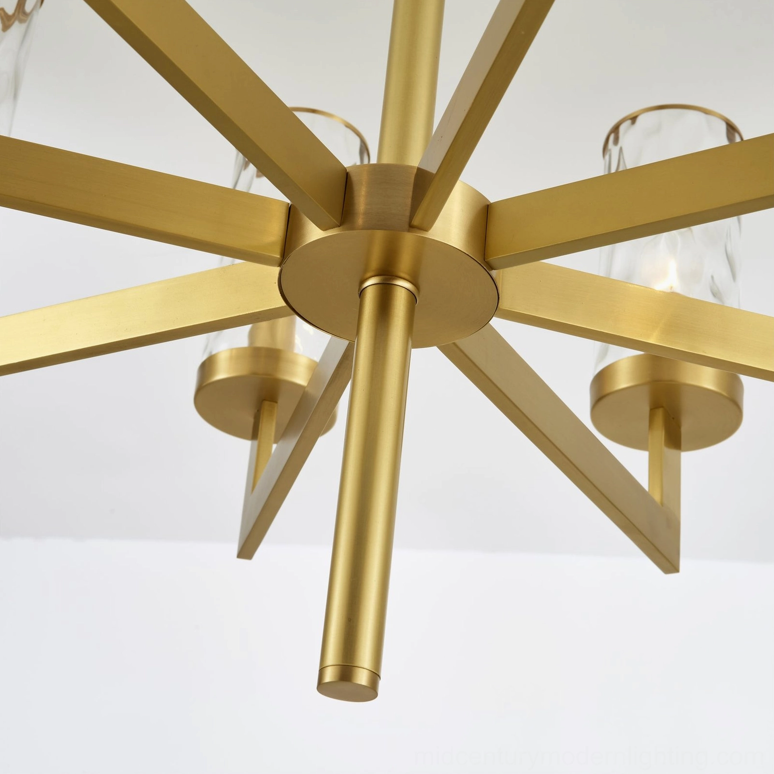 Detailed view of Liaison chandelier brass components and glass shade finishes
