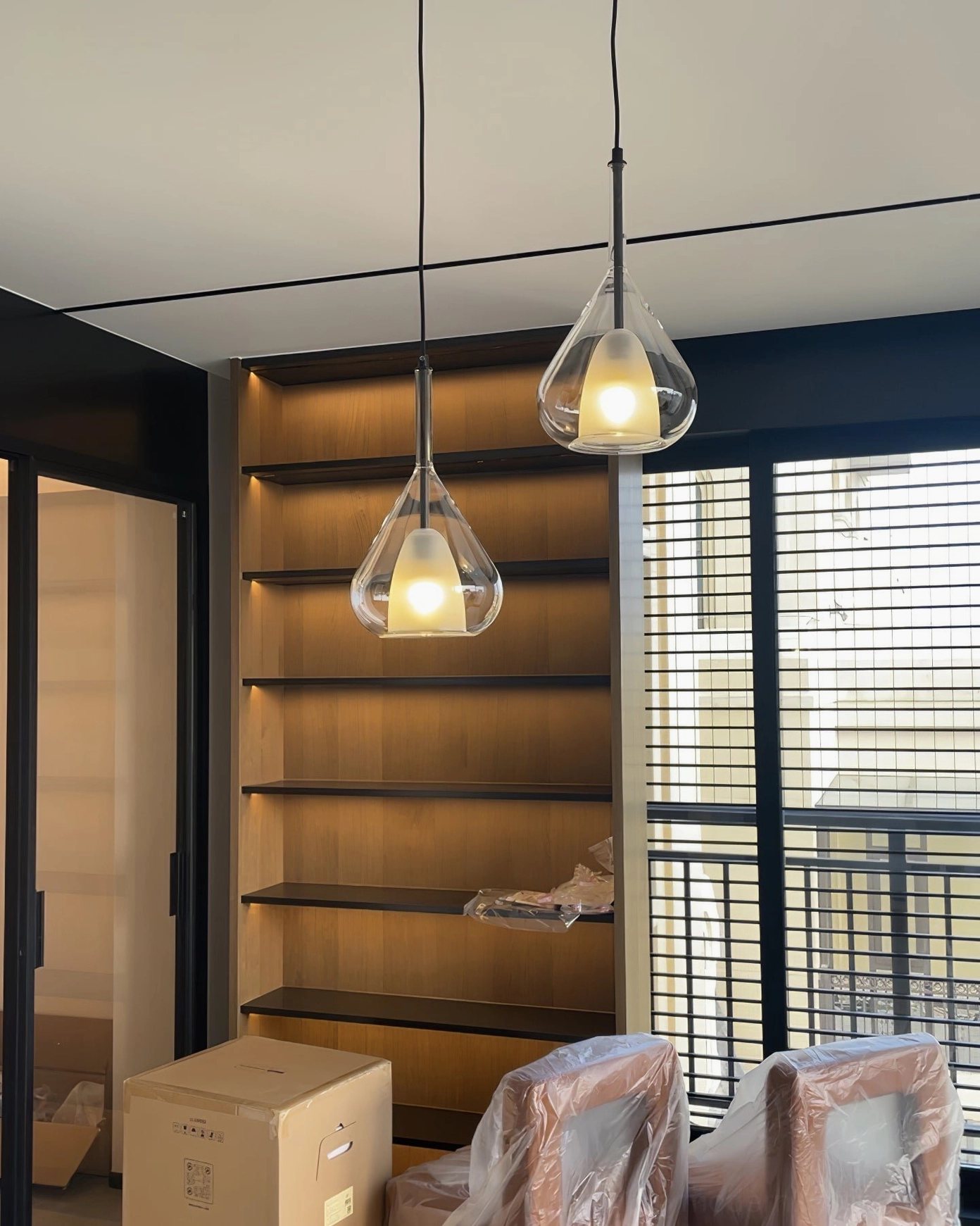 Dual Lila teardrop pendants suspended in modern study room creating warm ambient accent lighting