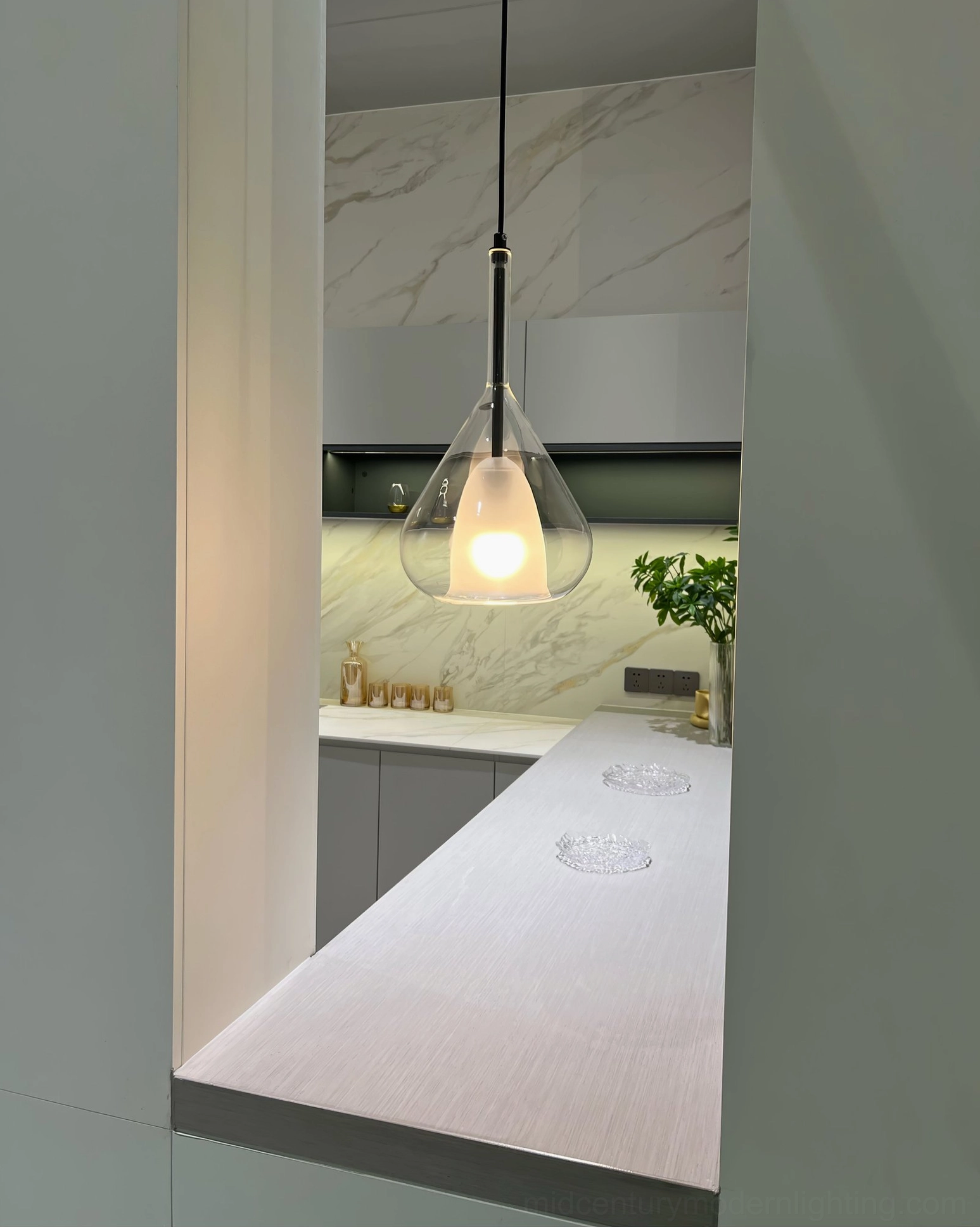 Lila pendant in clear glass variant with gold metal frame and modern interior styling