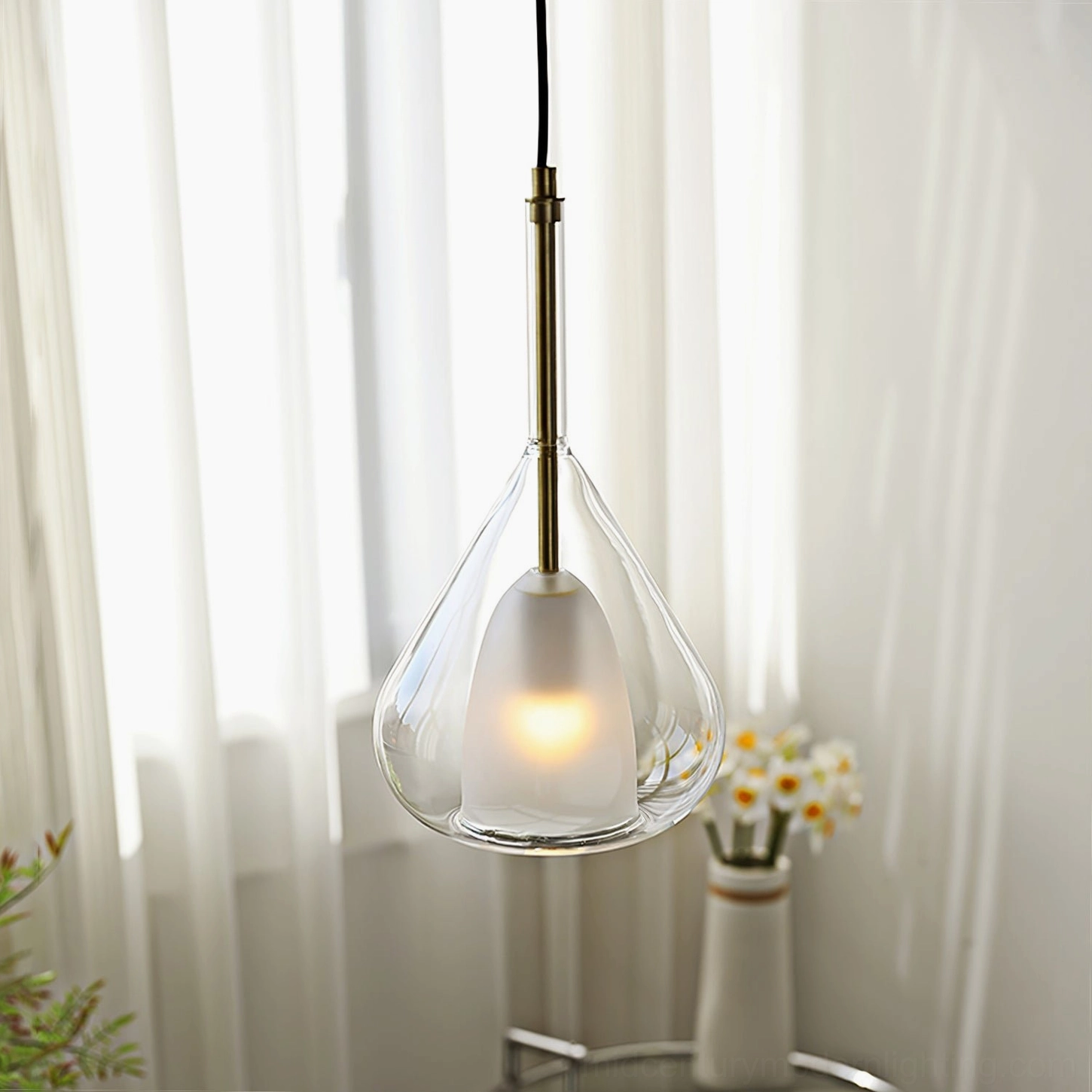 Close-up frontal shot of Lila teardrop pendant with natural daylight through sheer curtains
