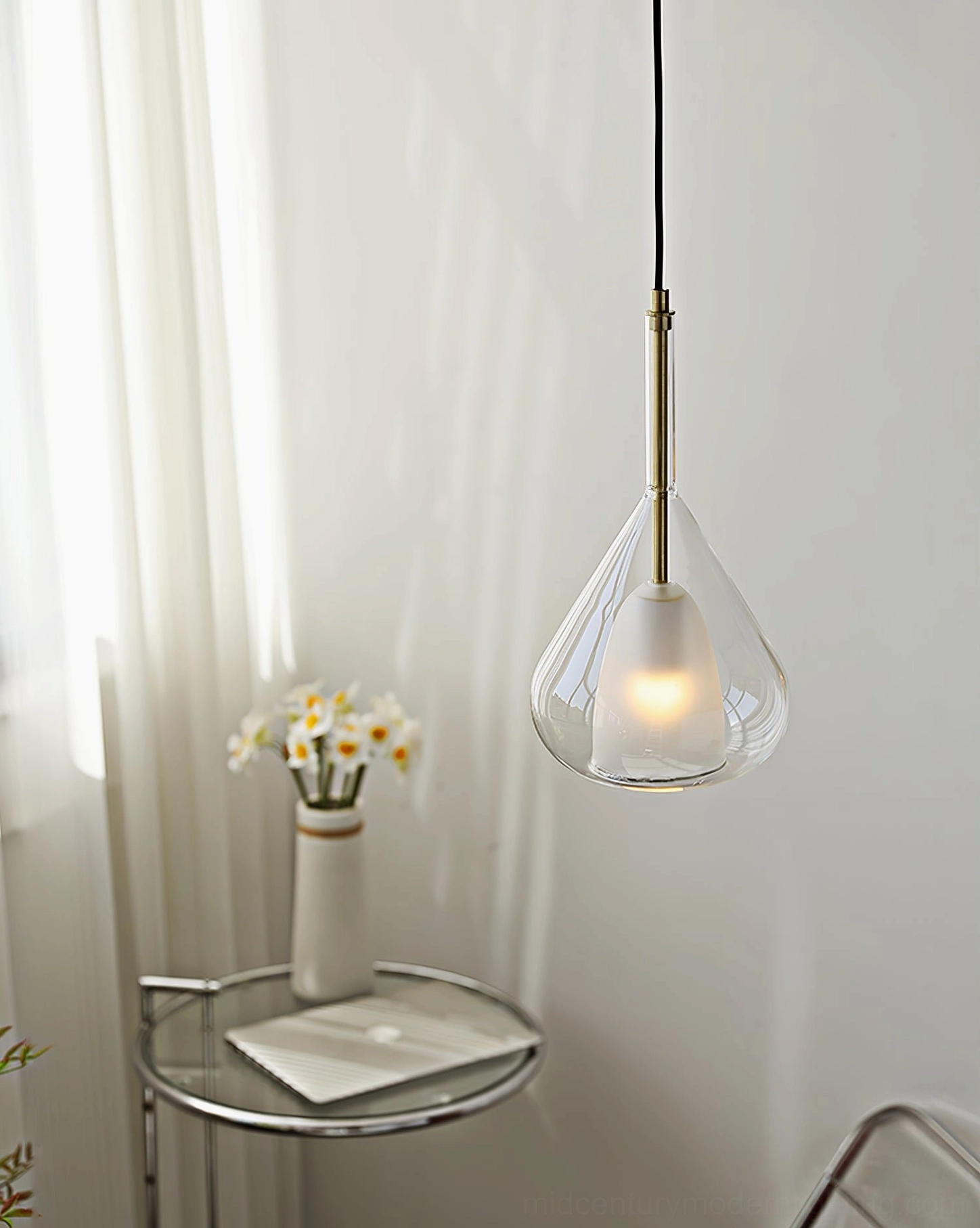 Lila teardrop pendant installed in minimalist Nordic apartment with small side table and warm lighting