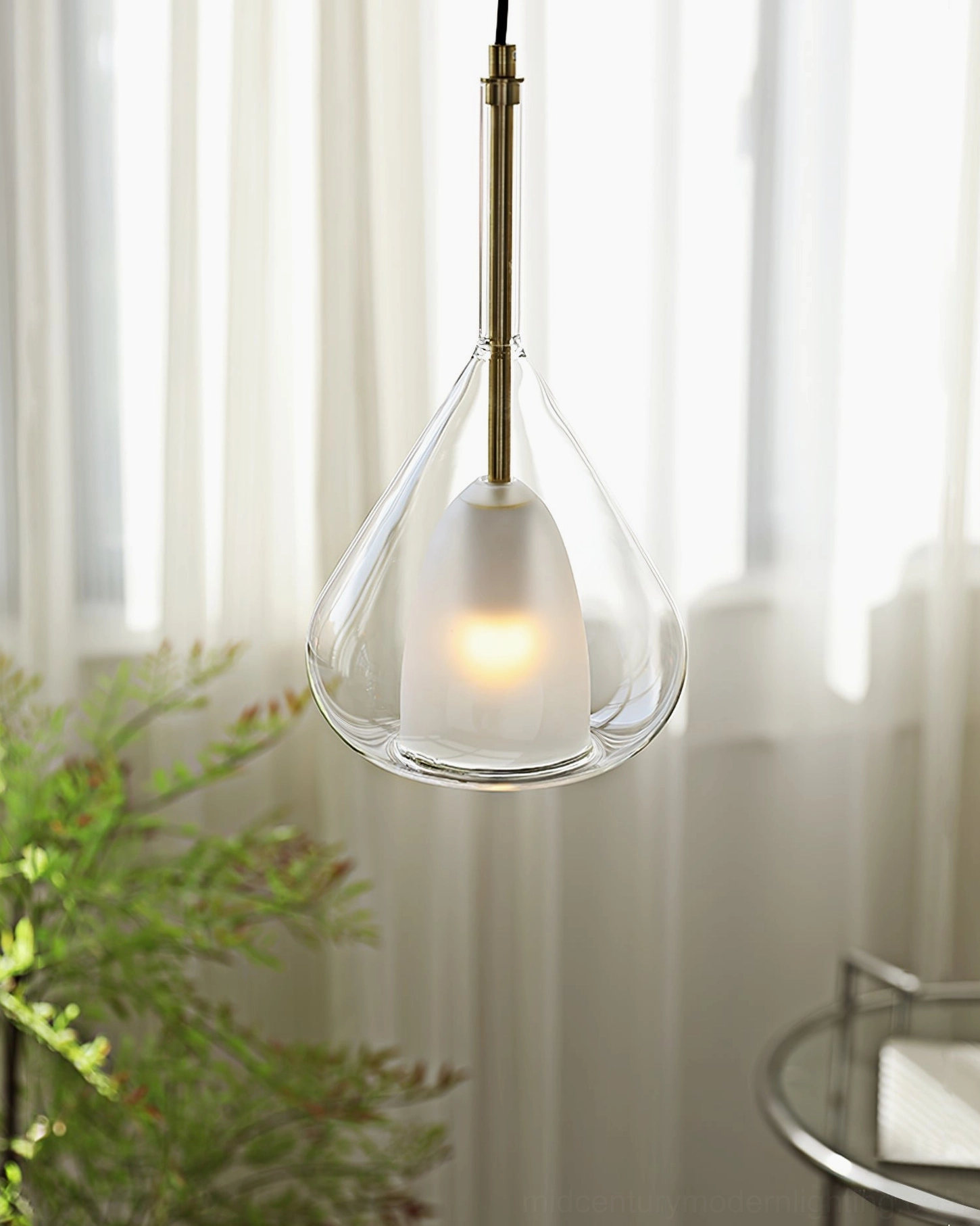 Lila pendant in smoke grey glass with gold metal finish creating sophisticated shadow play