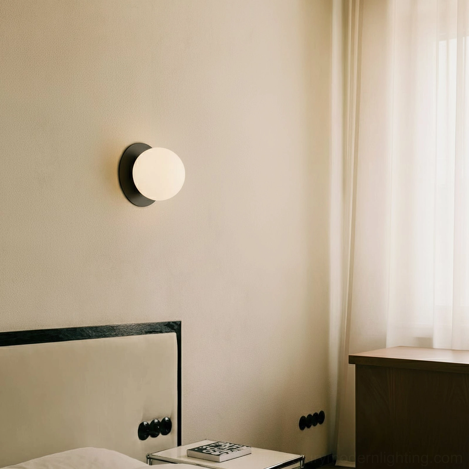 Lila wall sconce brass finish installed beside modern bedroom bedside table with warm ambient lighting