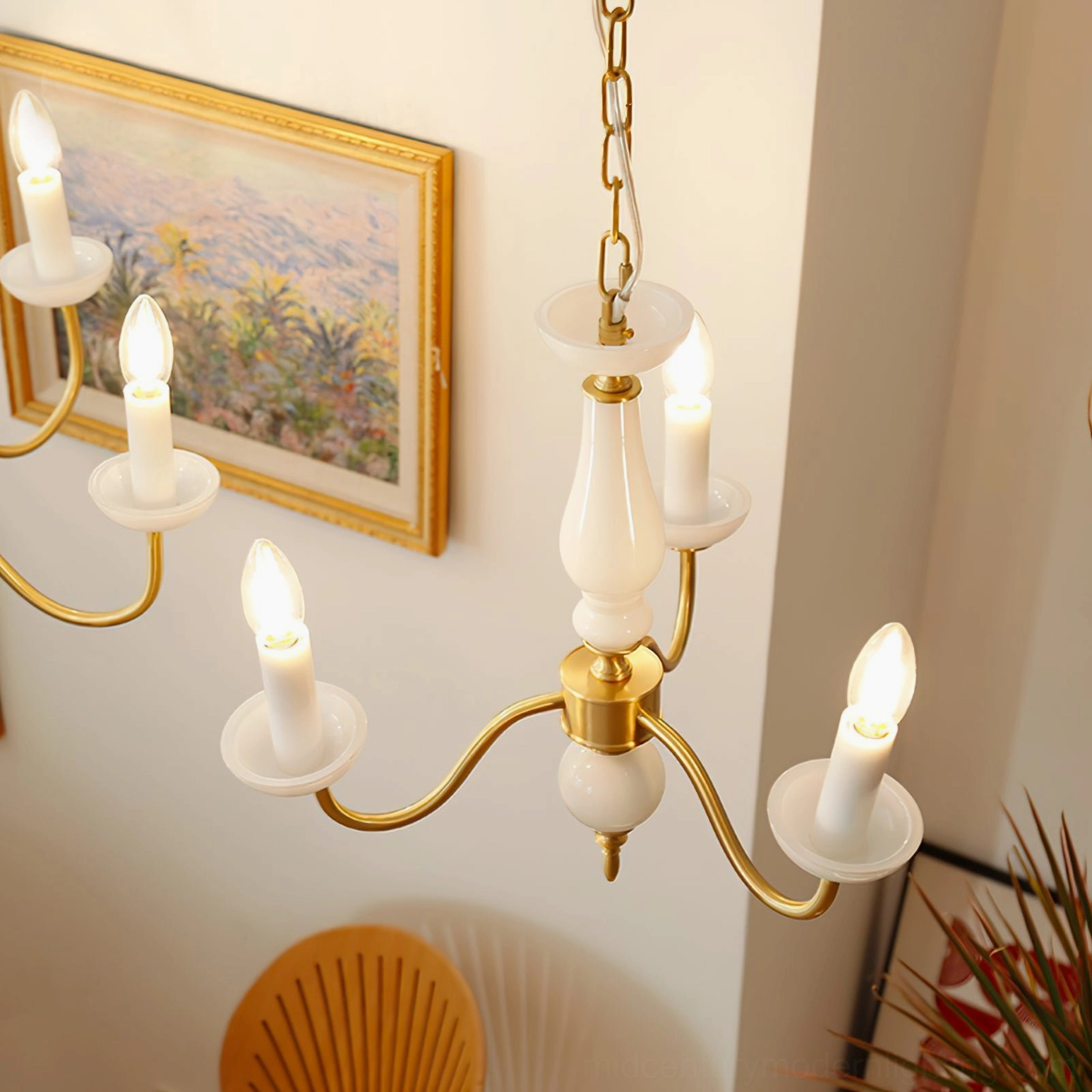 Illuminated Lillianne candle chandelier with warm lighting in vintage French interior decor setting