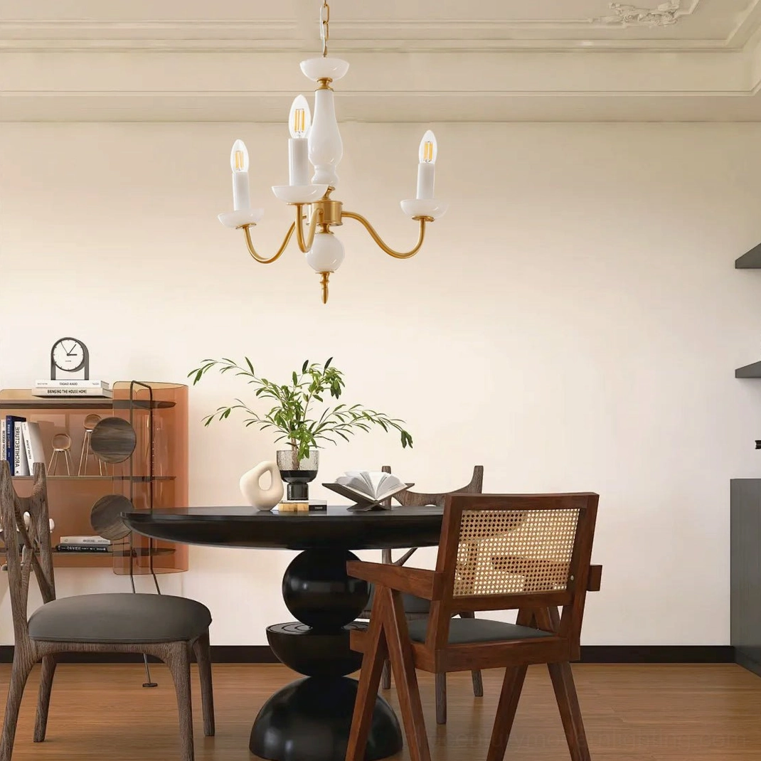 Lillianne candle chandelier suspended over round dining table in warm vintage dining room environment