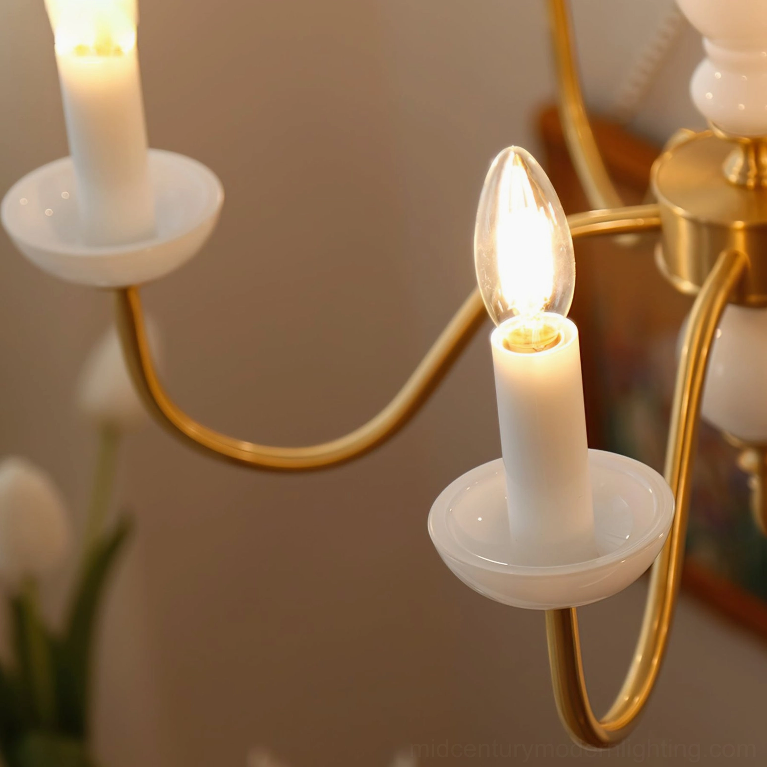 Close-up of Lillianne chandelier candle sleeves and E14 bulb sockets with brass curved arms
