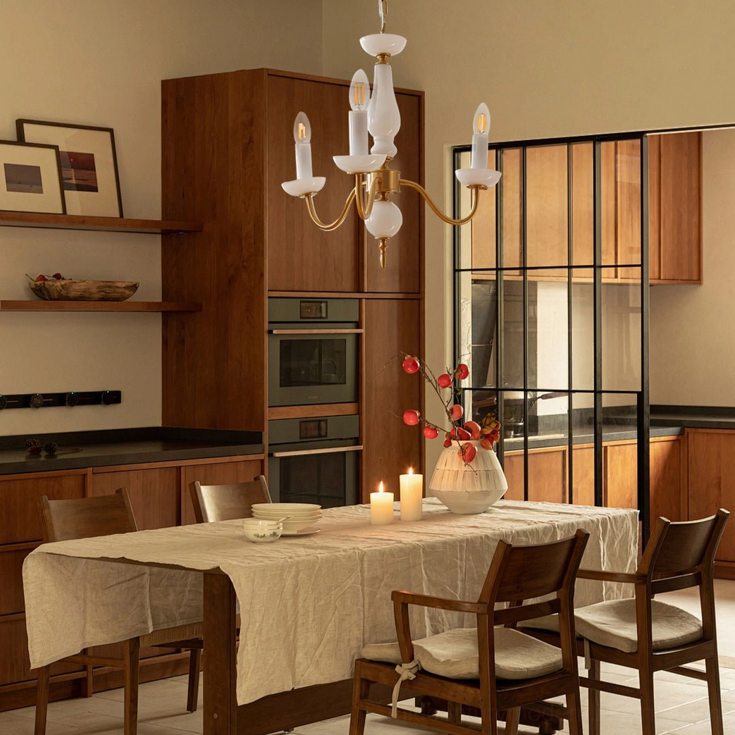 Brass and white candle chandelier in warm wood-tone vintage kitchen dining space with retro styling