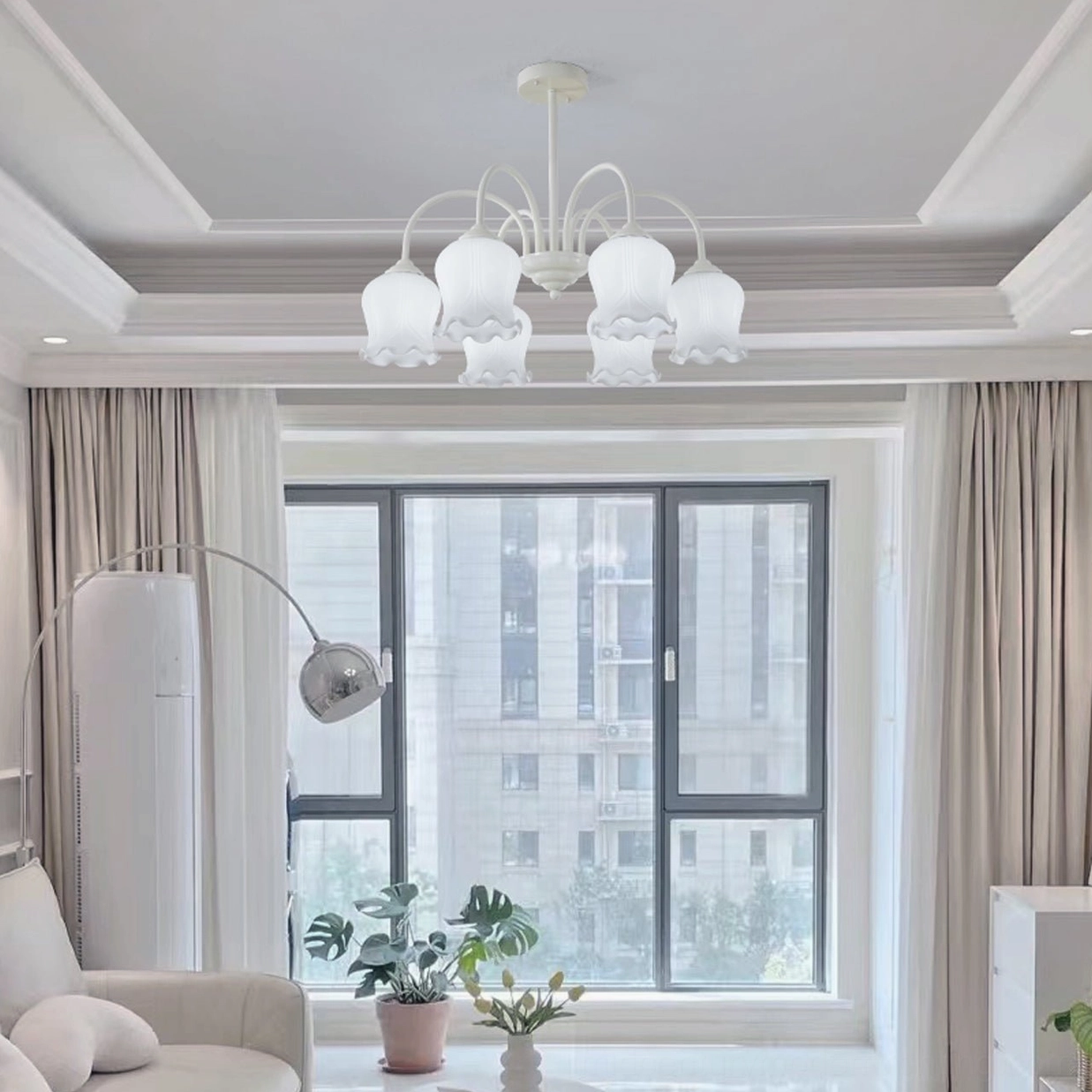 Lily chandelier warm white finish illuminated showing soft diffused glow through frosted shades