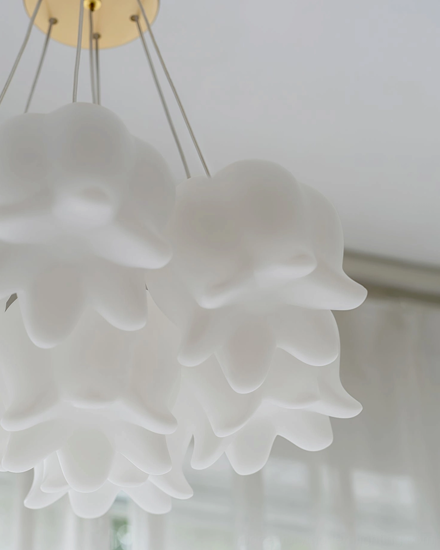 Frosted acrylic flower shade detail on lily of the valley multi-pendant ceiling chandelier showing matte finish and light diffusion quality