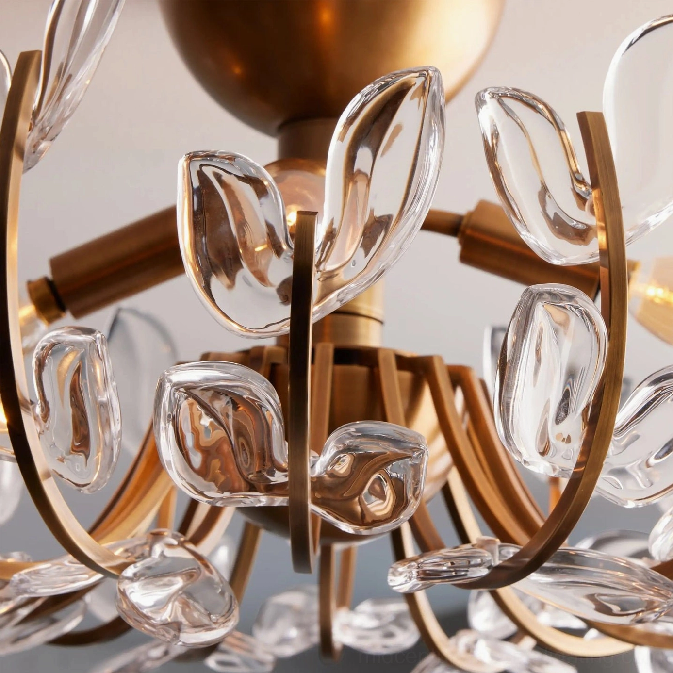 Close-up detail of Lindsay flush mount light showing brushed brass frame and precision-cut clear glass leaf accents