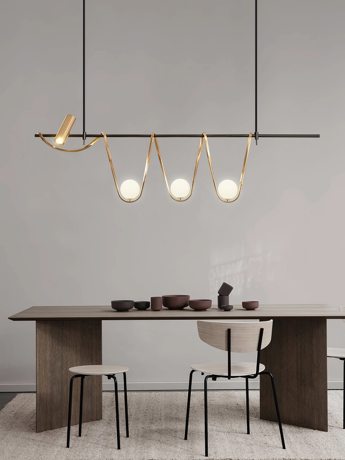 Modern linear island pendant in minimalist dining space with wooden table - mid-century modern lighting fixture