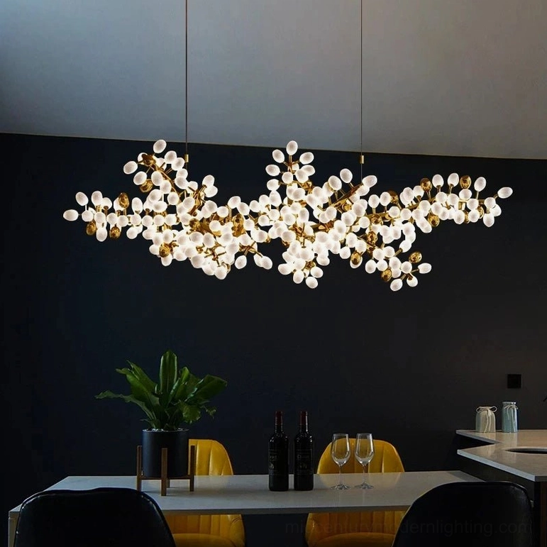 Linear cluster chandelier with brass gold branches and frosted glass orbs in compact modern dining nook