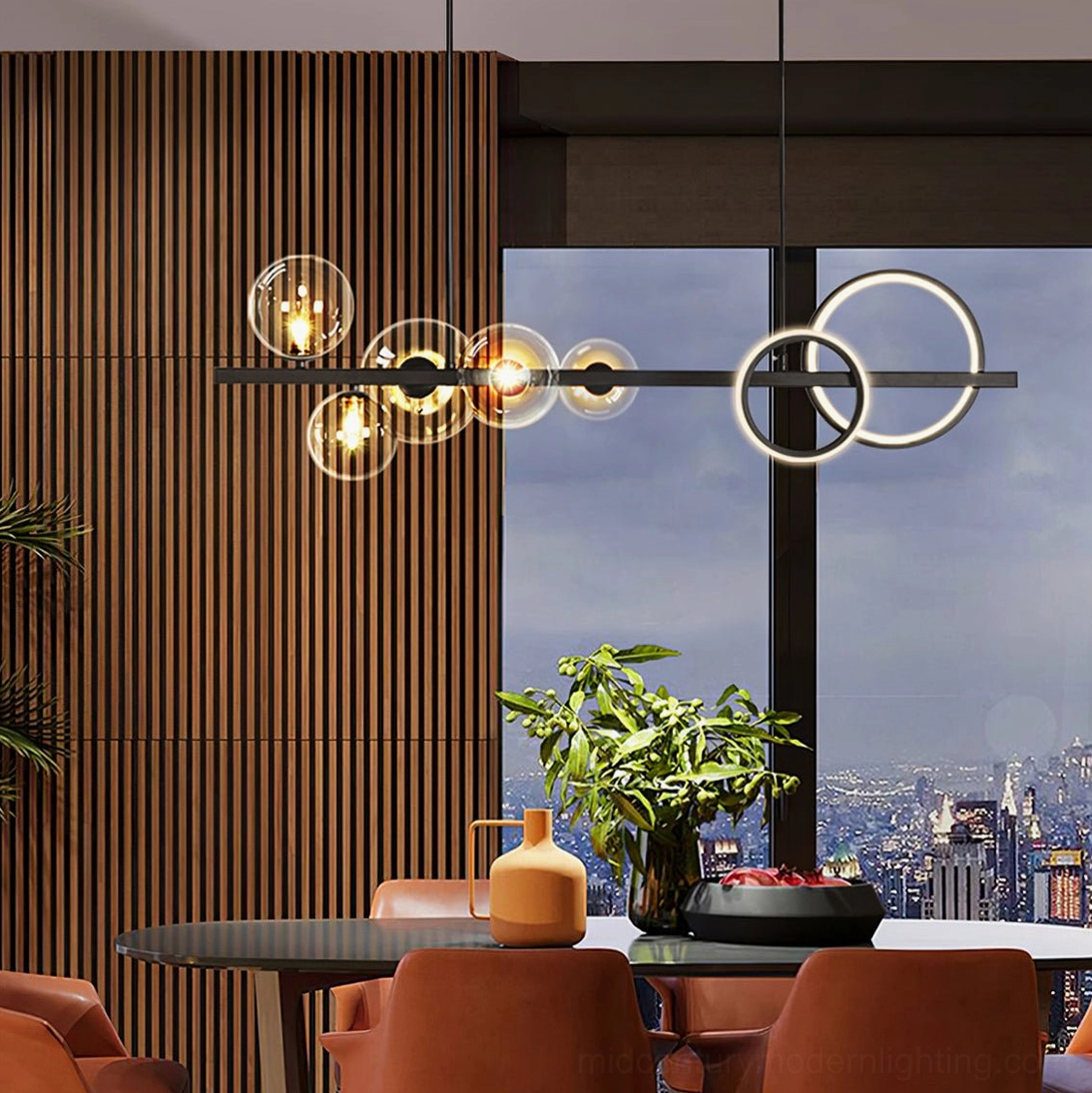 Modern linear glass pendant chandelier with warm glowing bulbs and black metal frame in high-rise dining room overlooking city skyline