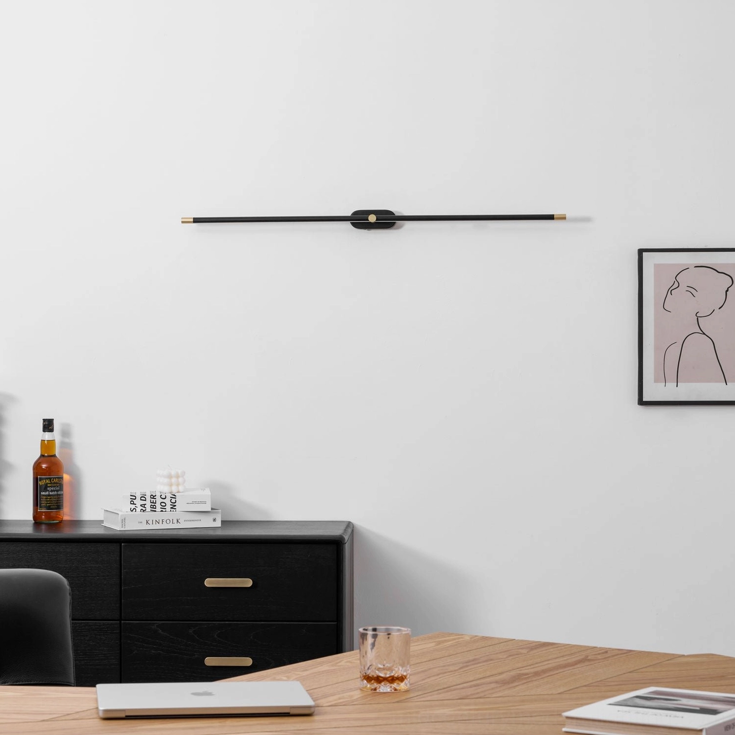 Modern linear wall lamp installed above console table creating ambient accent lighting focal point