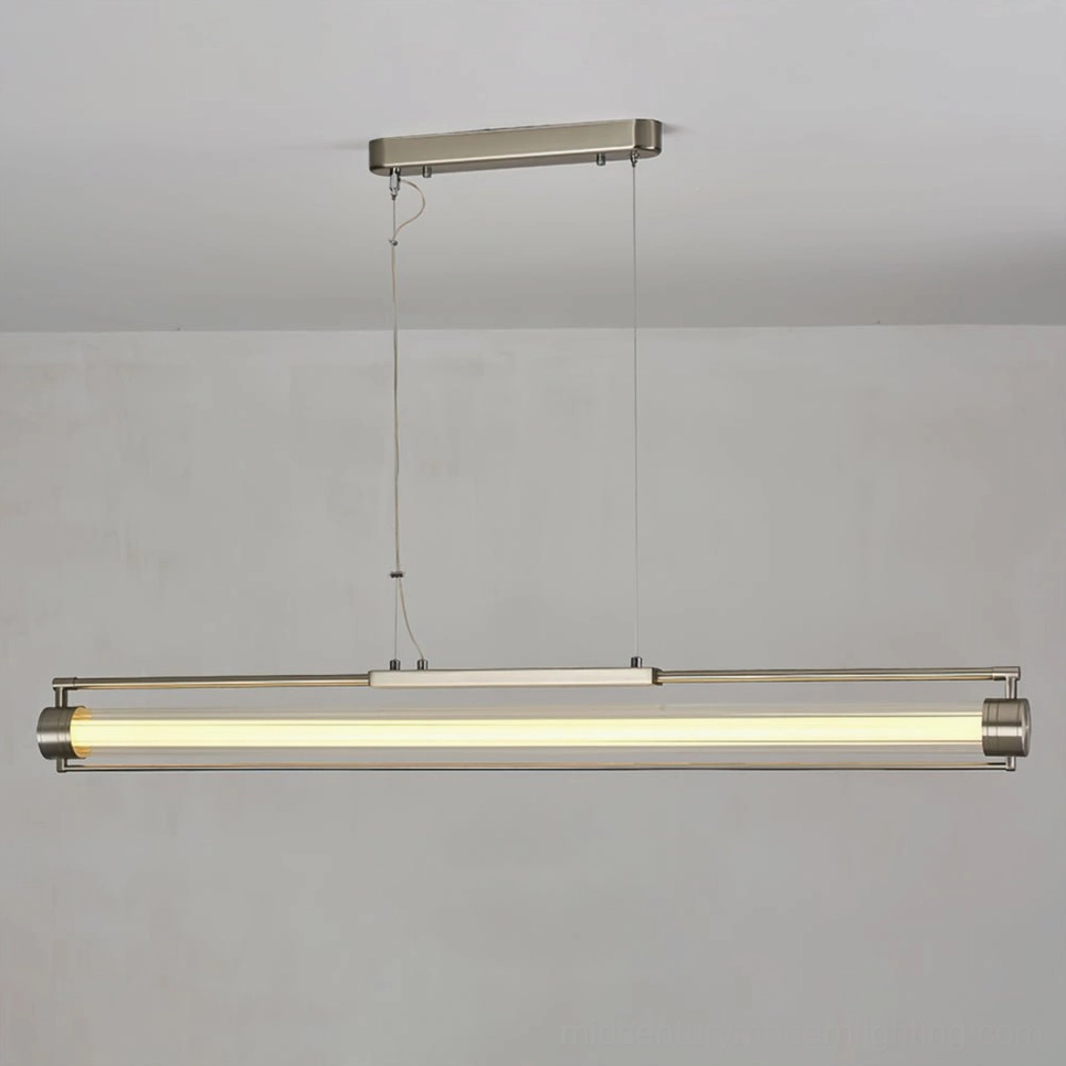 Lirna LED pendant light illuminated with warm white light against gray wall backdrop