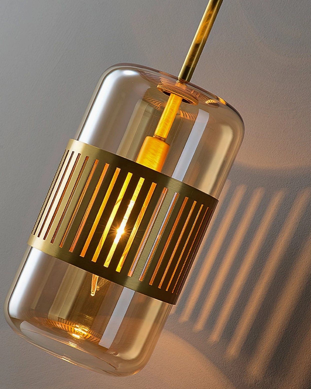 Lizak amber glass wall lamp in warm interior context, showing how glass shade diffuses and filters light beautifully
