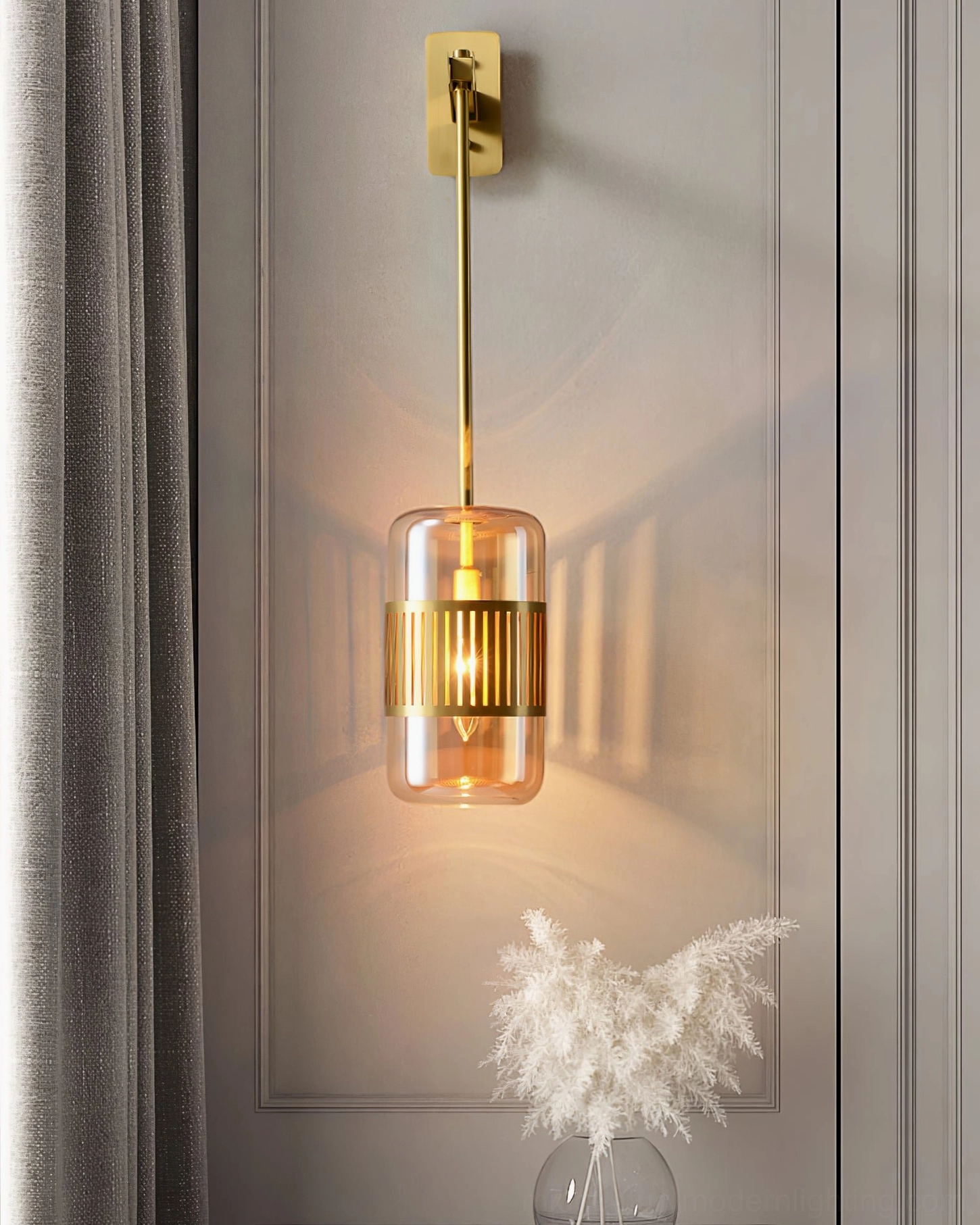 Lizak amber glass sconce creating warm shadow patterns on wall, demonstrating light diffusion and ambiance quality