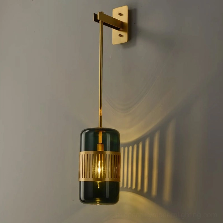 Lizak brass wall sconce with green glass shade, studio lighting showing color depth and brass warm tone finish