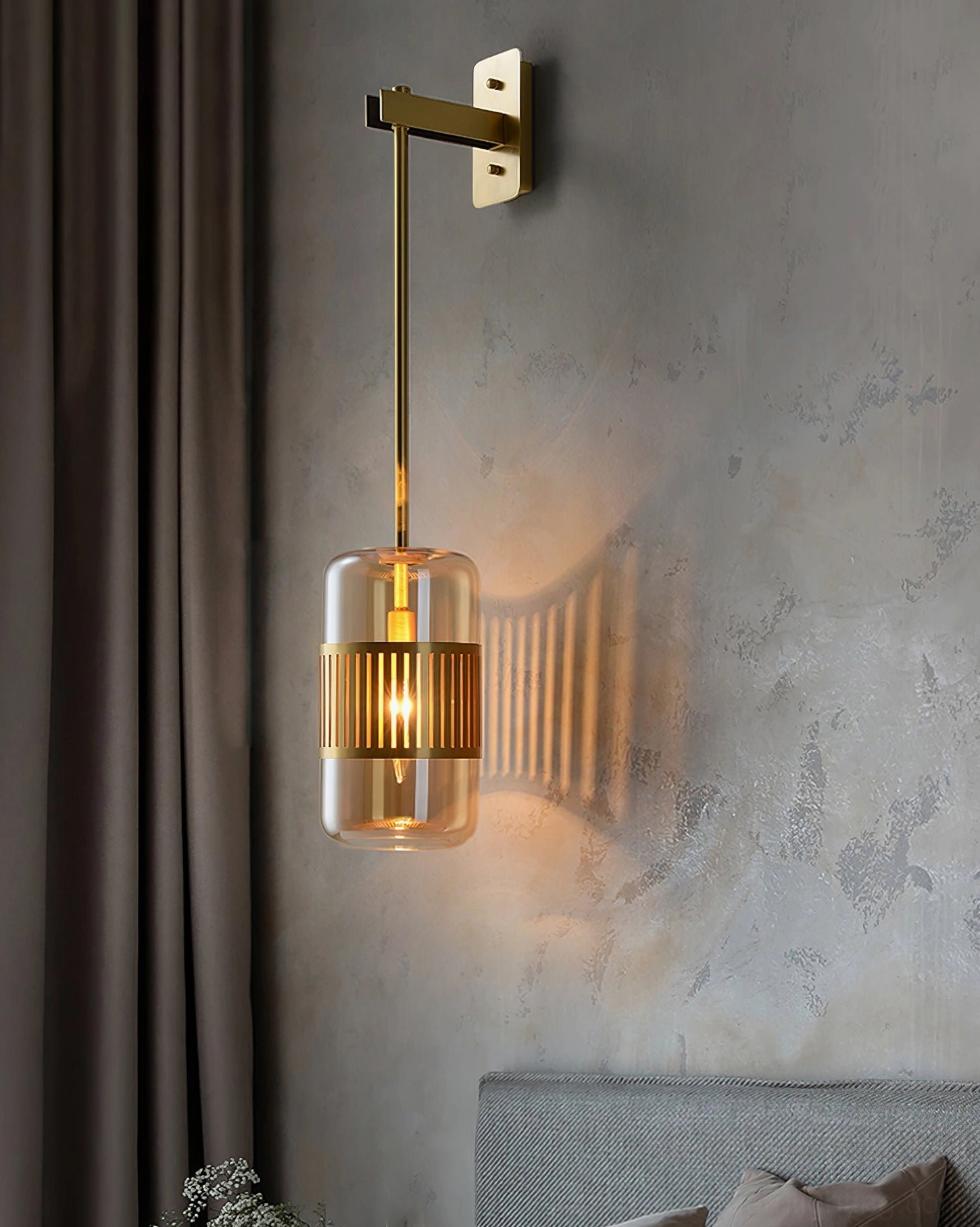 Lizak brass wall sconce mounted in hallway or corridor, creating wayfinding visual interest with sculptural shadow play