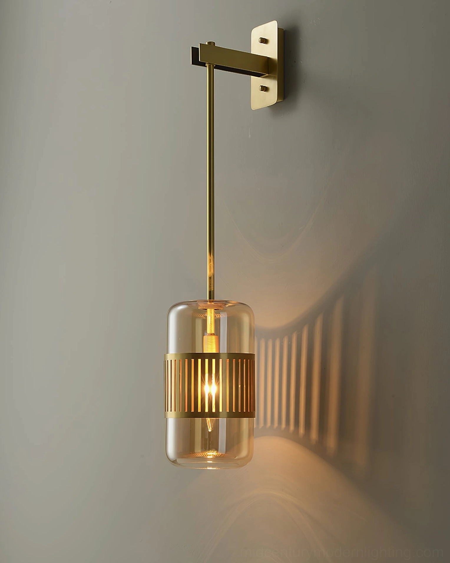 Lizak wall lamp in industrial contemporary space, showing brass-glass combination with concrete and metal elements