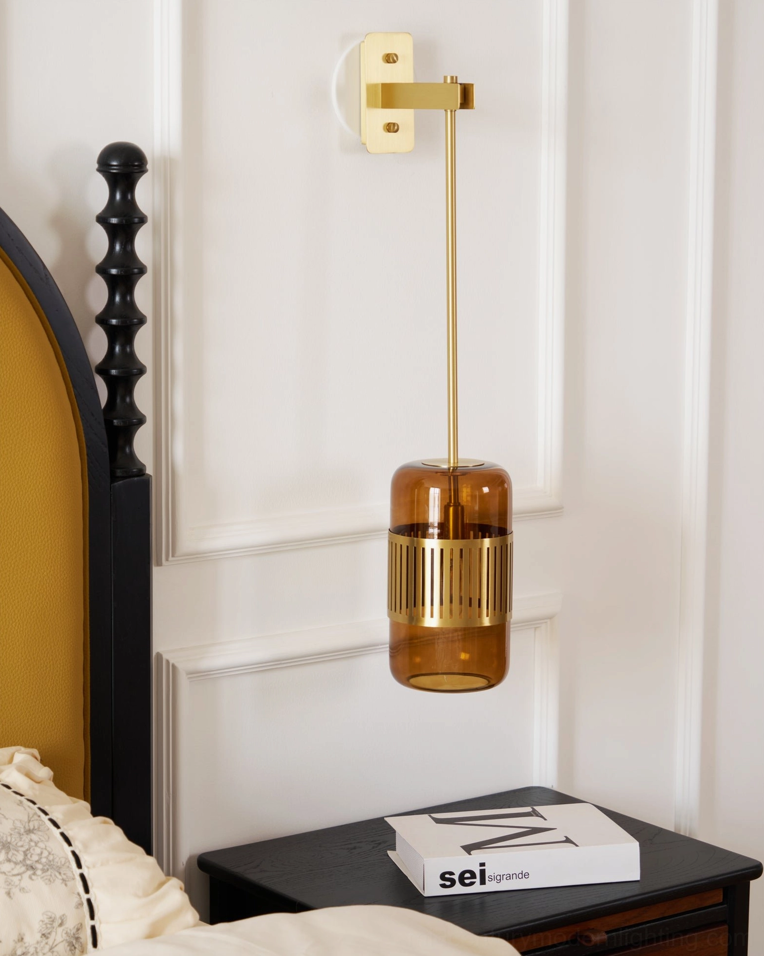 Lizak bedside wall lamp on white paneled wall showing modern minimalist design, soft warm light from amber or green shade