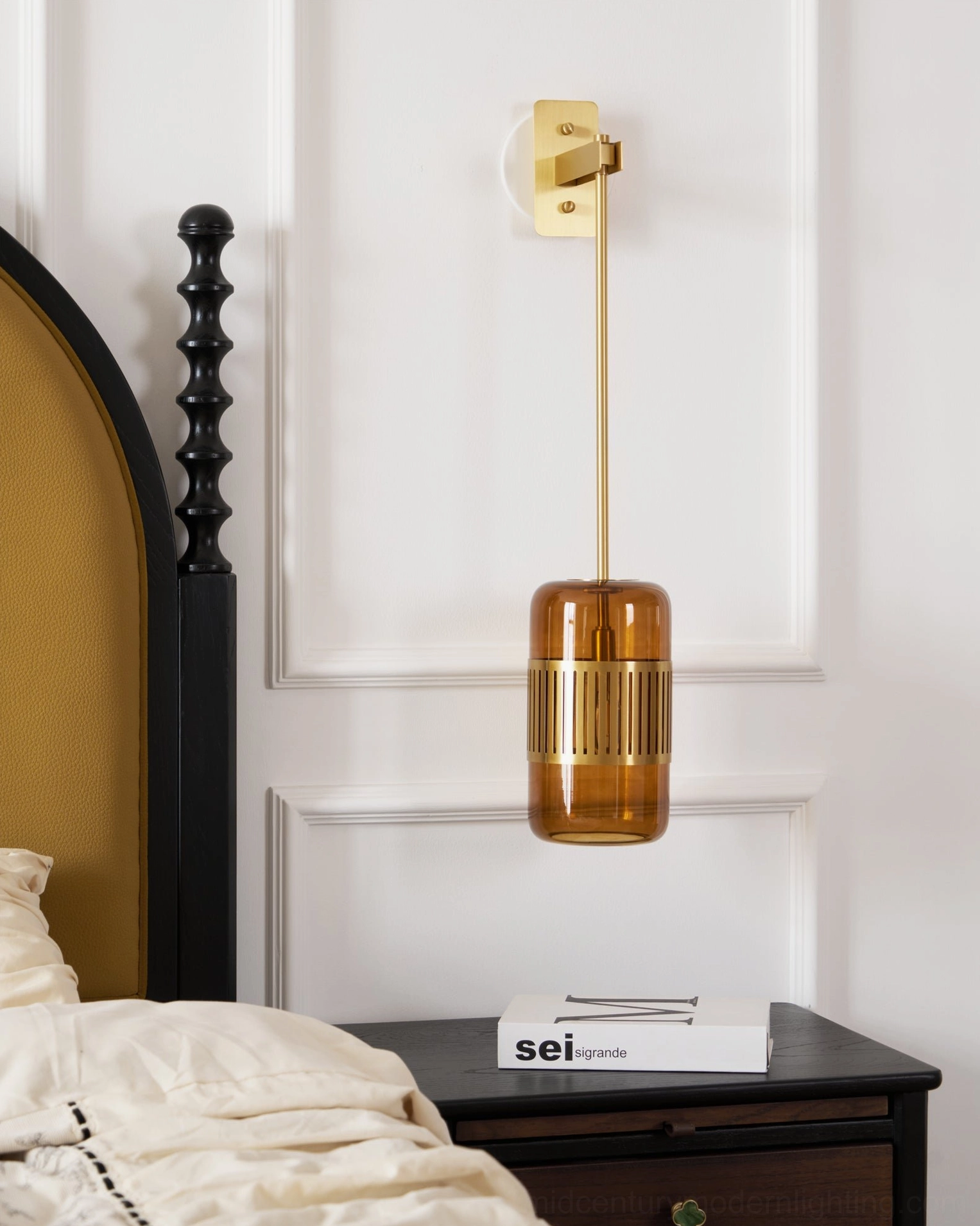 Lizak brass wall sconce with slatted trim detail mounted on white paneled wall, showcasing architectural lighting design