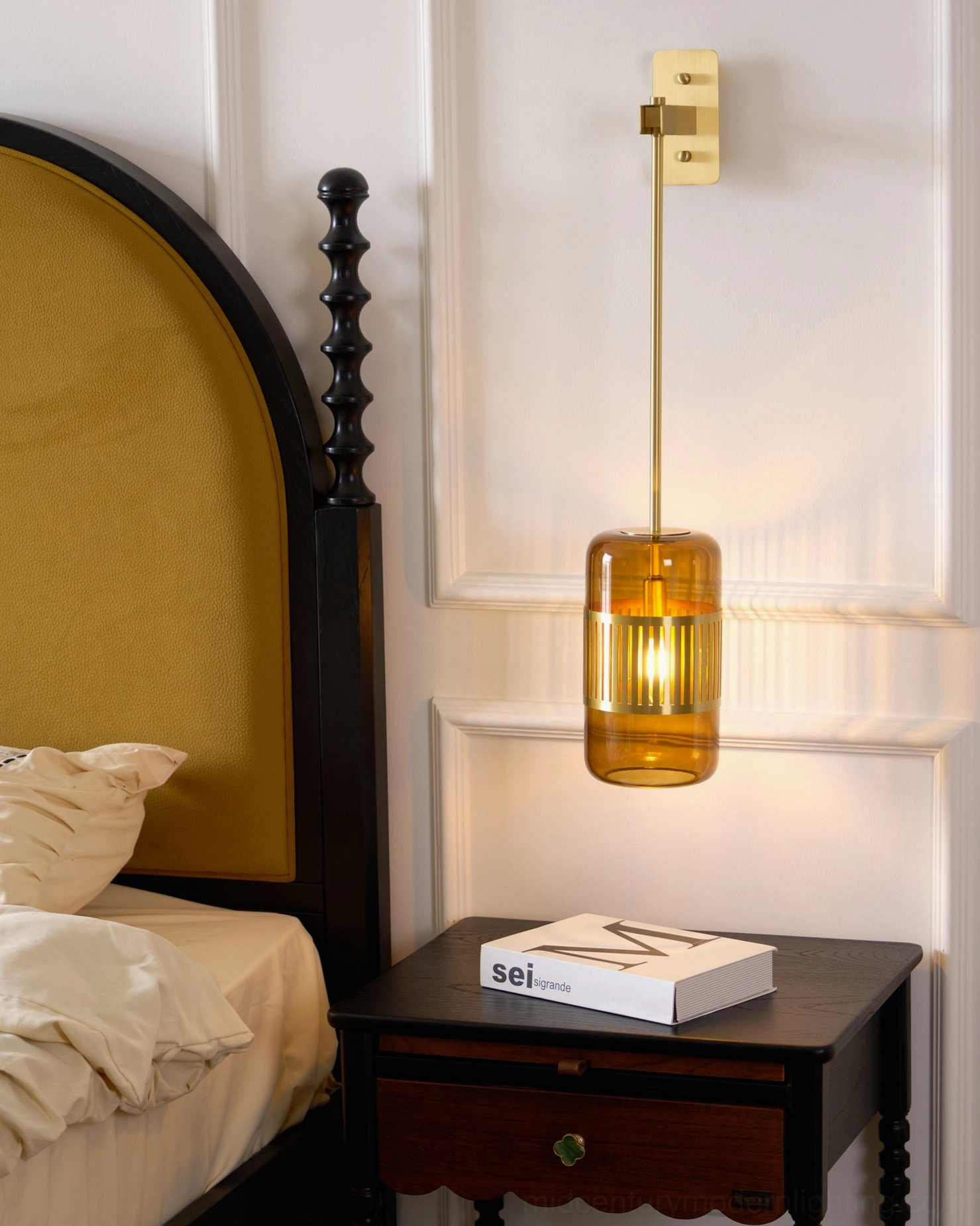 Lizak wall lamp installed on white paneled bedroom wall, eye-level view showing clean modern installation without metal trim