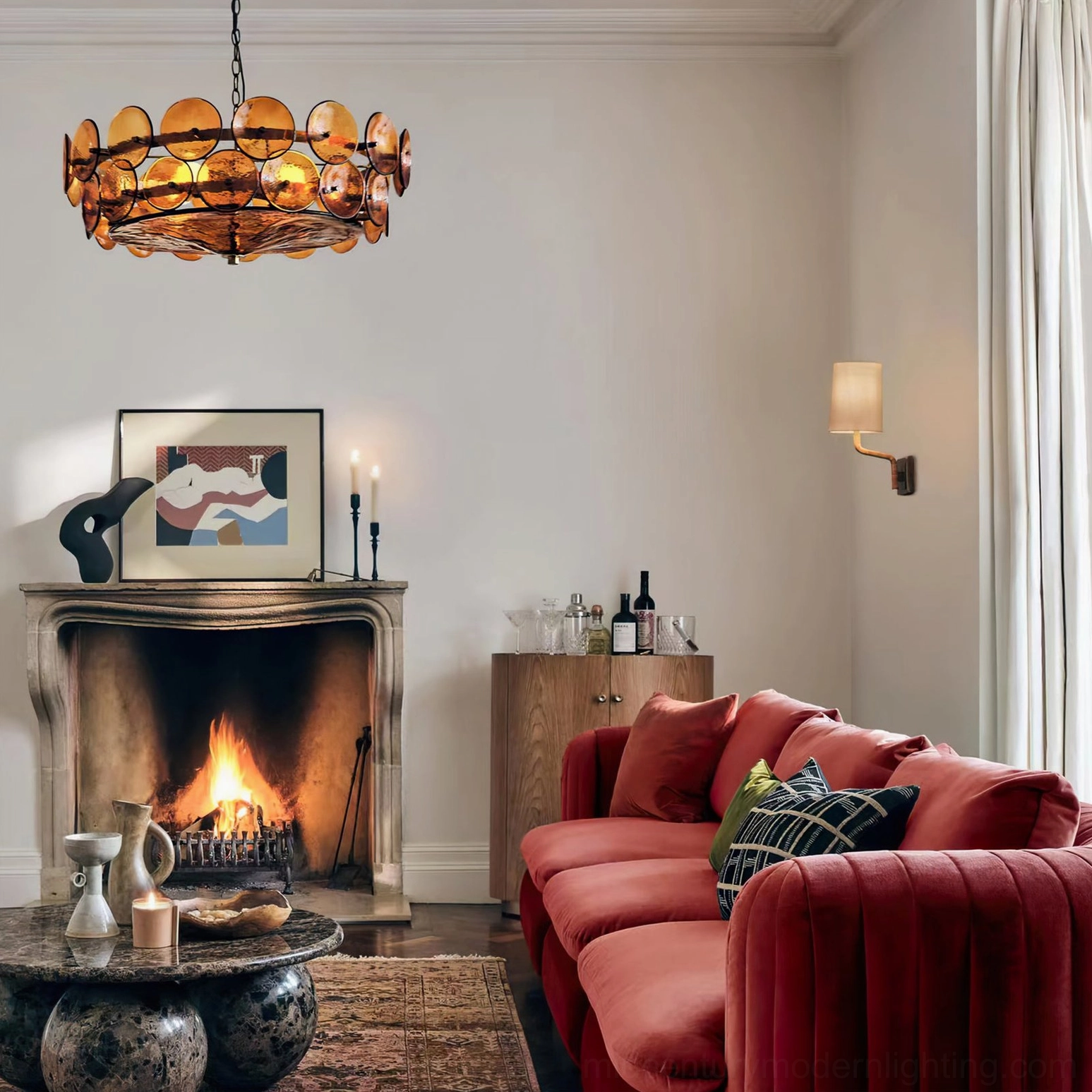 Amber Lorenzo chandelier in retro living room with fireplace, red velvet sofa, and warm ambient lighting