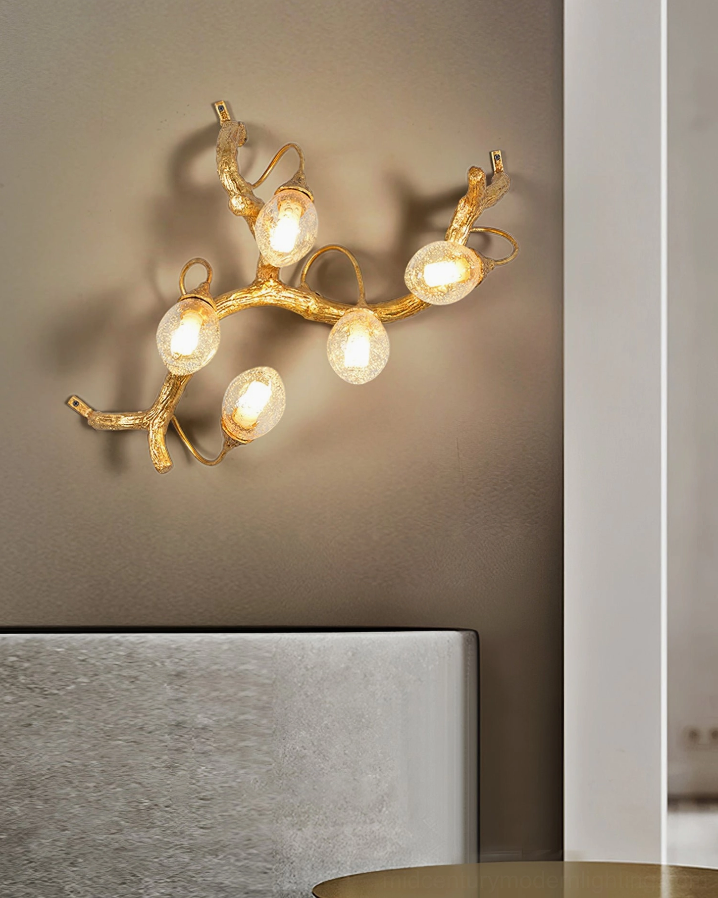 Lotus brass wall lamp in bedroom setting with upholstered headboard, ambient light glow