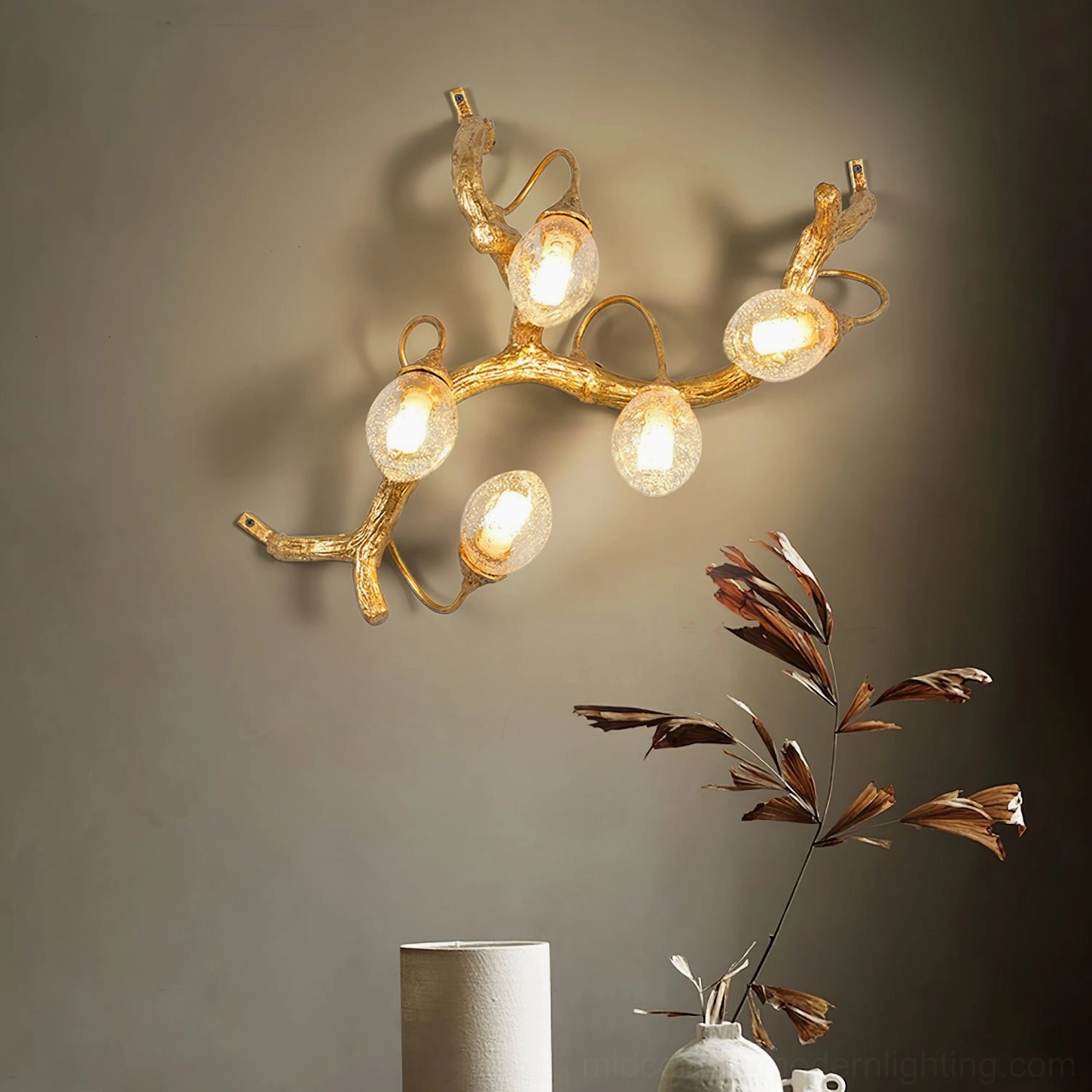 Lotus brass wall lamp installed in modern living room with green foliage decor, warm ambient lighting