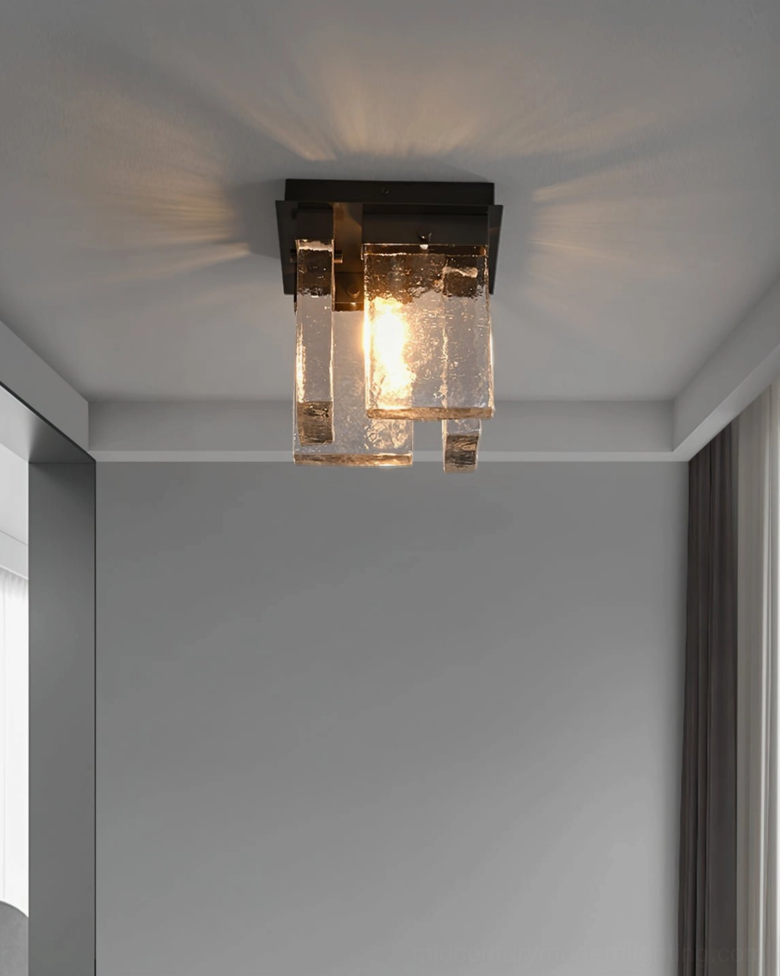 Flush mount black ceiling light above double glass doors in contemporary luxury entryway foyer
