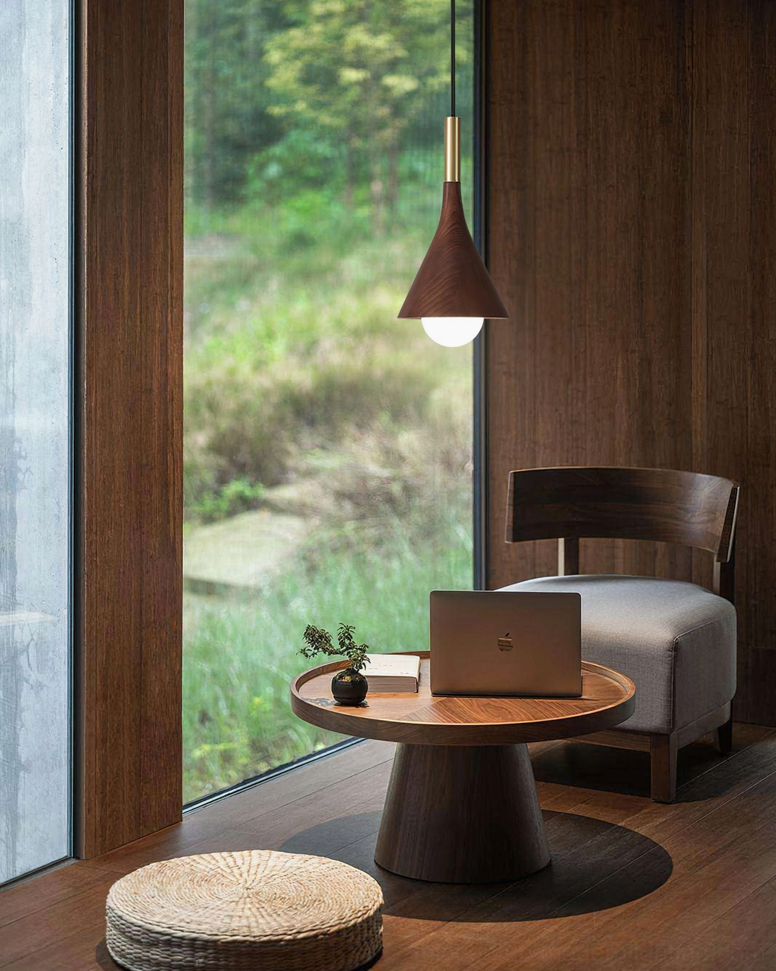 Single Lucian walnut pendant light in cozy bay window with natural greenery