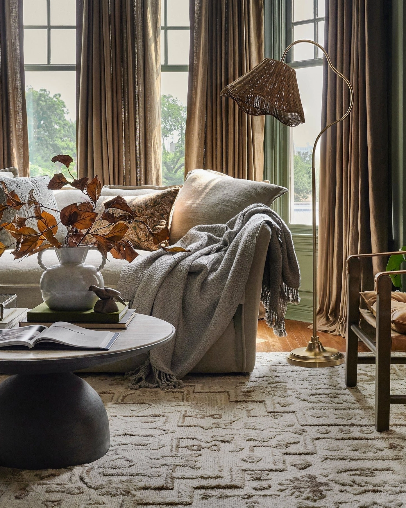 Lucinda rattan floor lamp in cozy farmhouse living room setting with warm bohemian decor and natural lighting