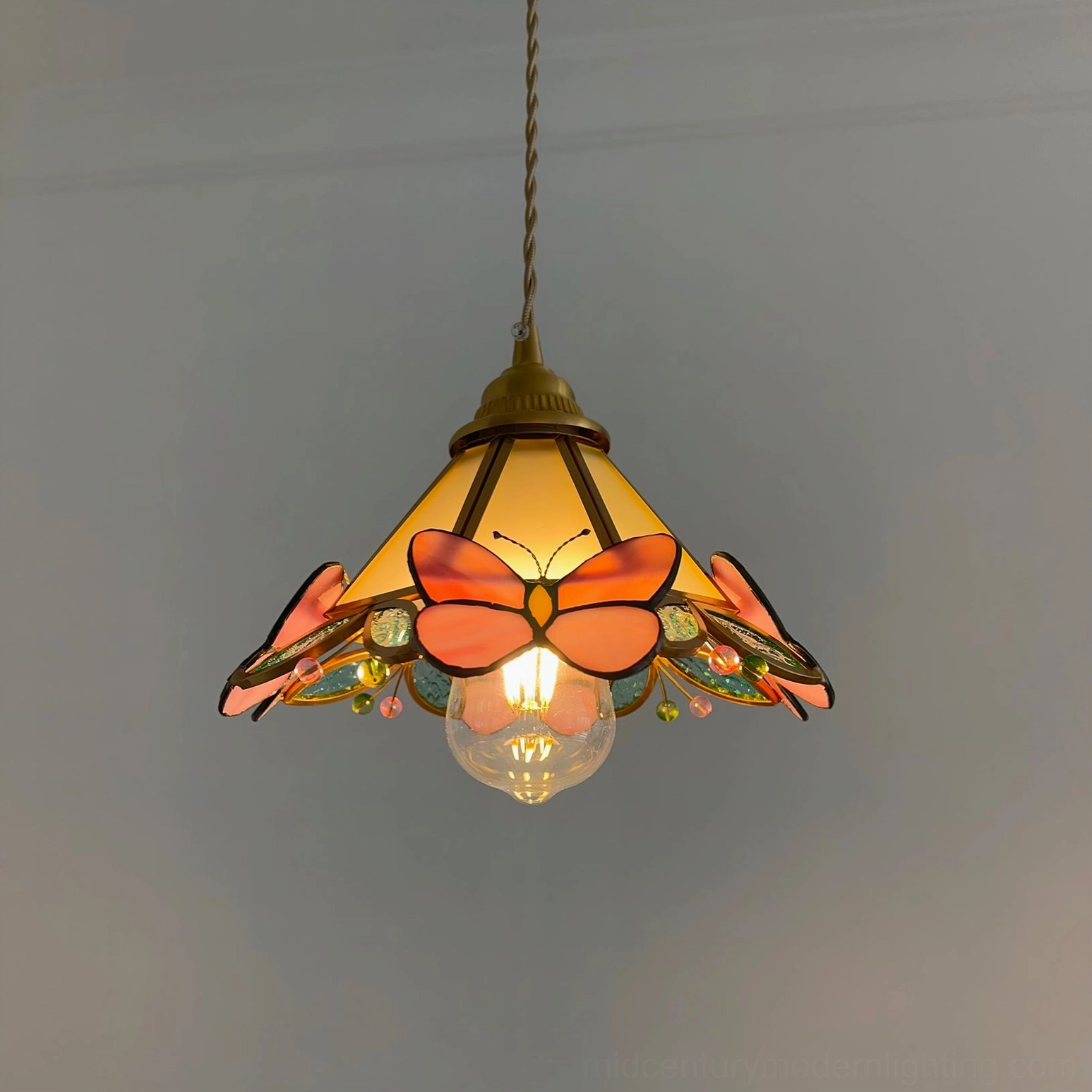 Brass and Pink Butterfly Pendant Lamp with Natural Light Showing Glass Color Saturation