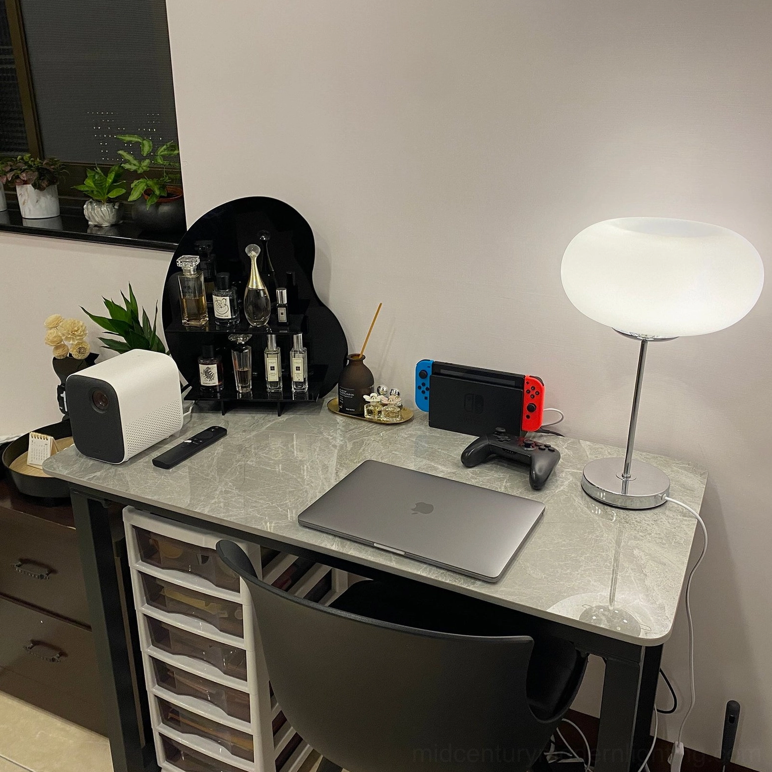 Contemporary silver table lamp with frosted glass diffuser, gaming office desk setup with laptop