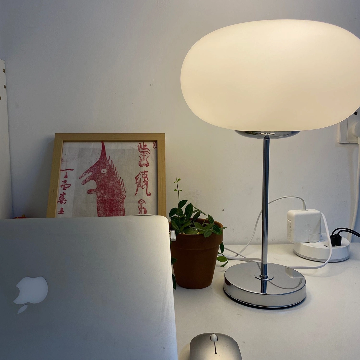Lumi minimalist table lamp on home working desk with laptop, potted plant and modern accessories