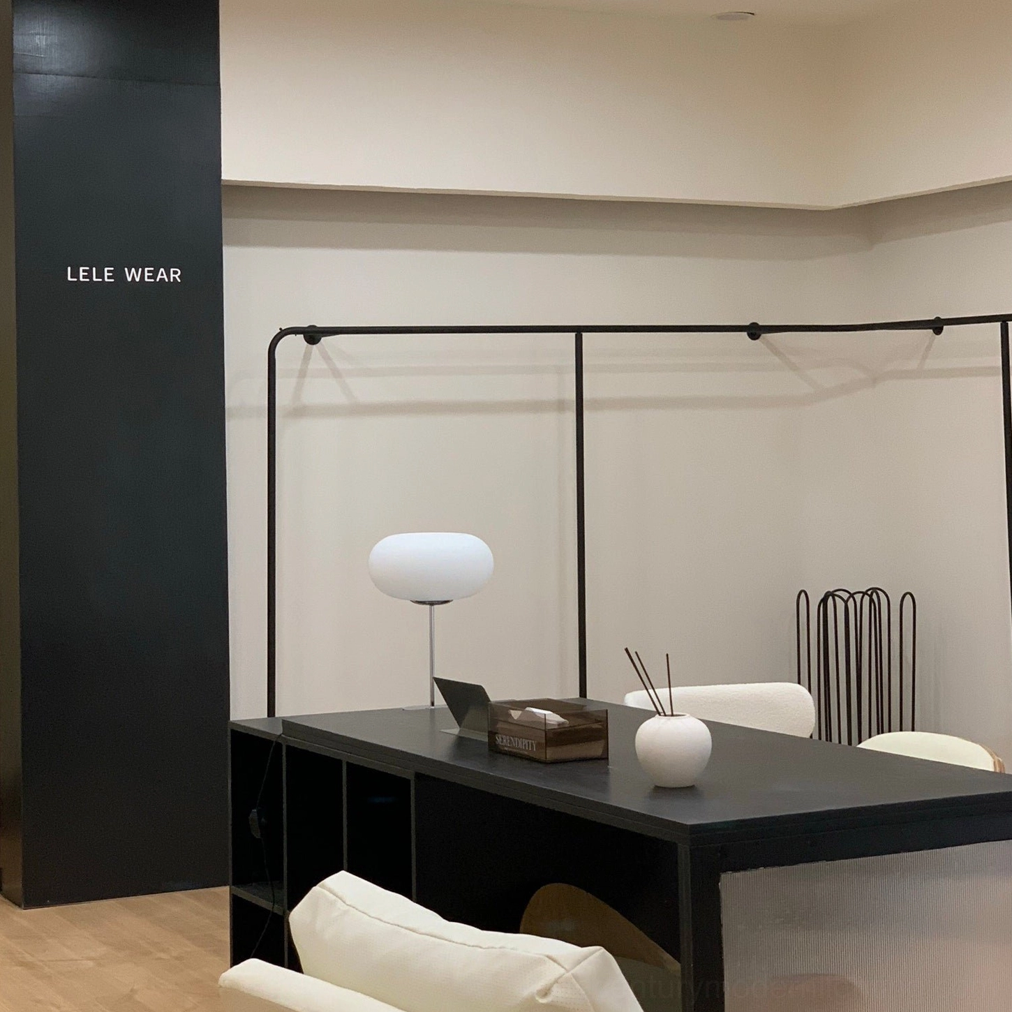 Minimalist modern table lamp in home office environment, wide room view with professional workspace