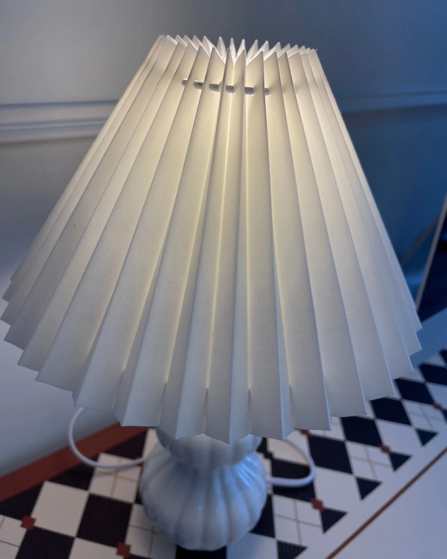 Luna pleated table lamp with potted plant and home decor accessories, curated desktop styling arrangement