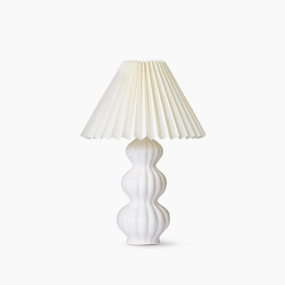 Luna pleated ceramic table lamp with white glazed base and natural beige pleated fabric shade, mid-century modern design