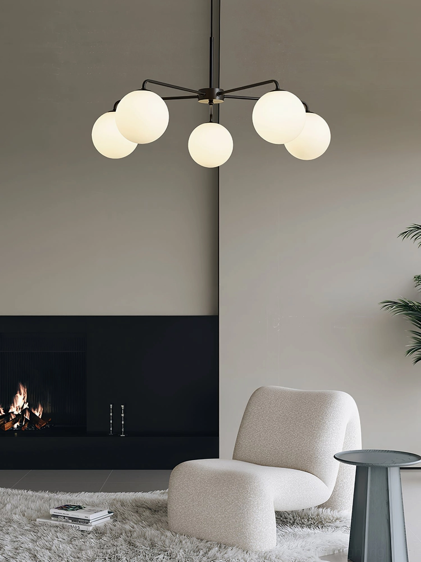 Lune black and white chandelier variant showing 5-globe configuration and light diffusion through frosted shades